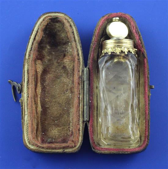 A cased late 18th century gold mounted cut glass miniature scent bottle with stopper and safety chain, approx. 2in.